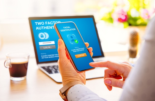 Cyber Liability Insurance Texas - Woman completing 2 factor authentication on her phone and computer 
