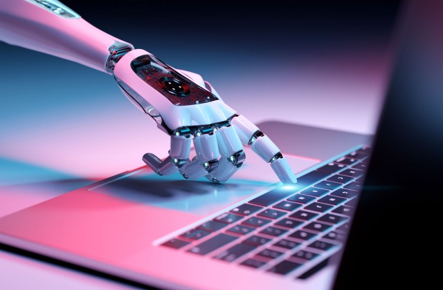 AI robot hand typing on computer - Cyber Liability Insurance