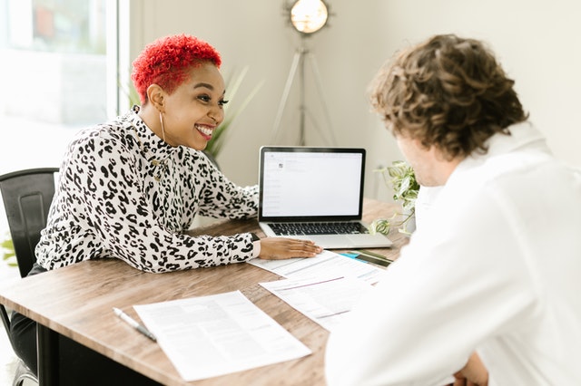 Woman reviewing application with client