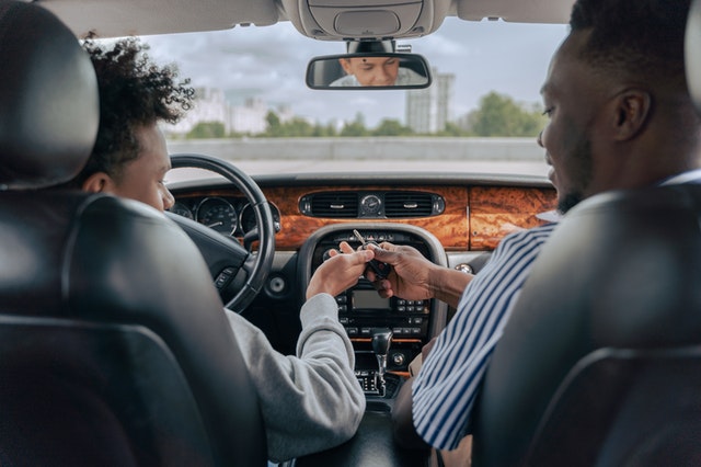 Best  Auto Insurance for Teenagers - teen in car with dad