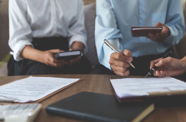 People reviewing insurance policy. Commercial Property Insurance guide