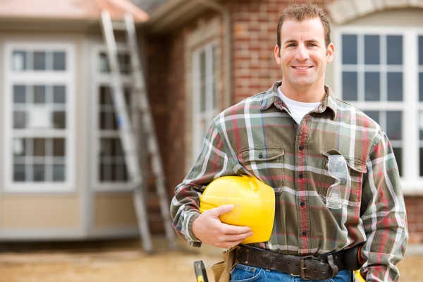 Construction Contractor standing in front of house - Contractor Insurance