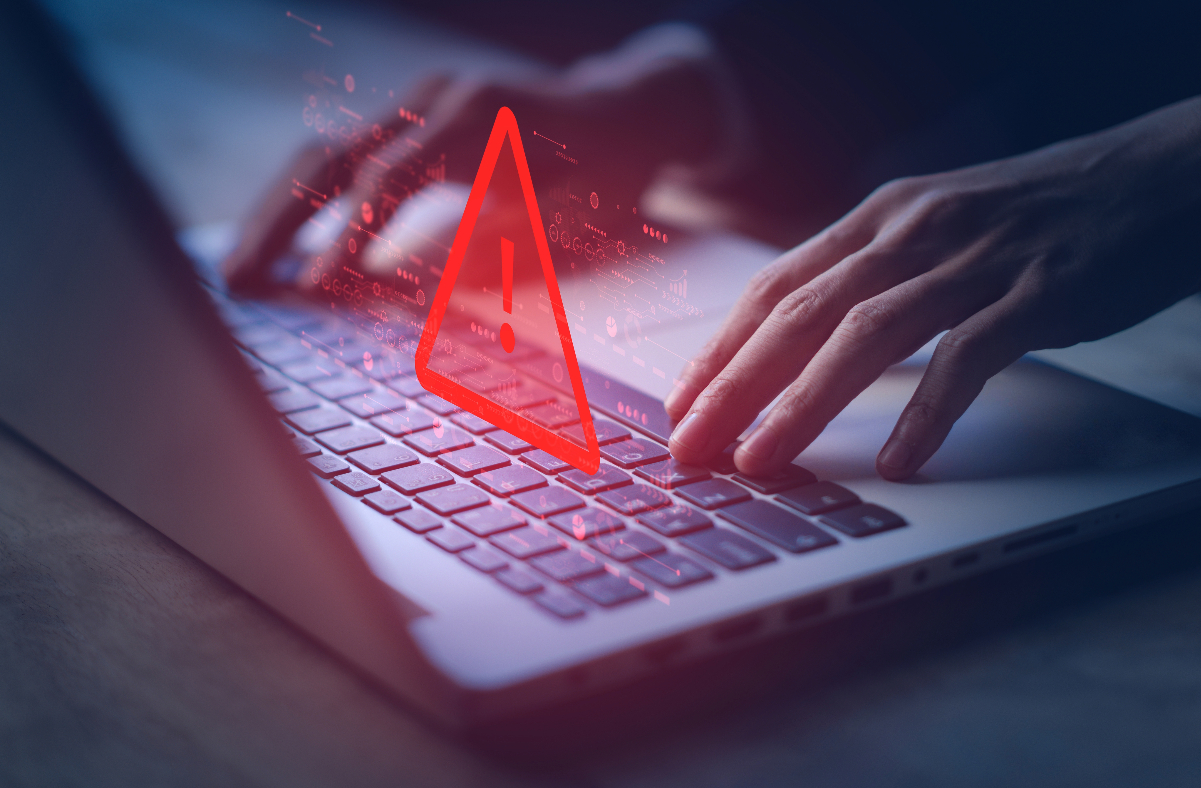 Laptop with cyber attack warning icon. Cyber Liability Insurance