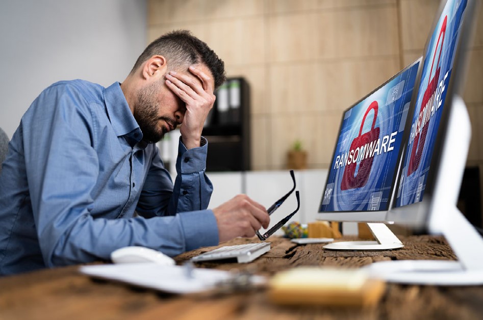 Man at computer facing a cyberattack. Cyber Liability Insurance