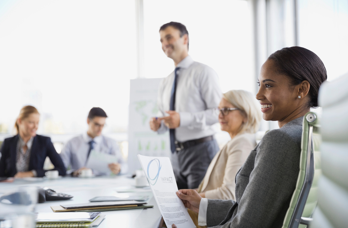 Board of Directors sitting around conference table discussing insurance