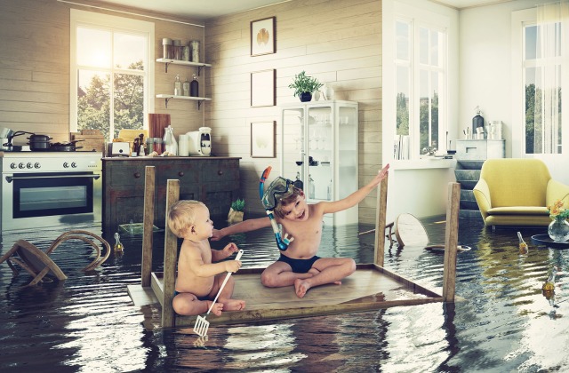 Flooded house with kids playing on coffee table - Flood Insurance Texas