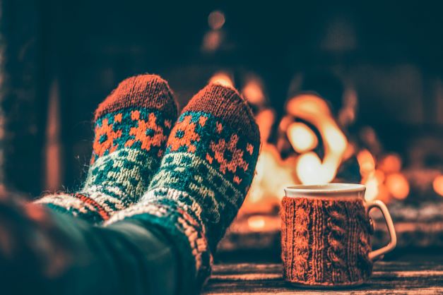 Holiday slippers in front of fire