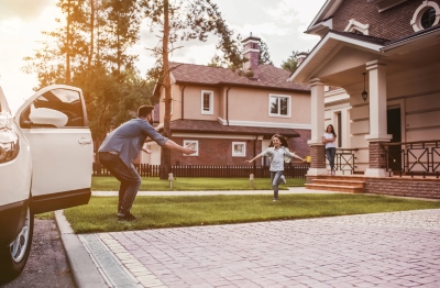 Family outside home with car parked - Home and Auto Insurance