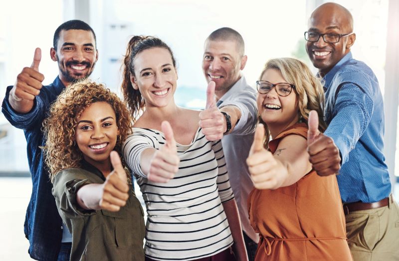 Group of adults giving a thumbs up to life insurance