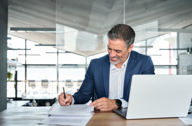 Businessman reviewing documents - Management Liability Insurance