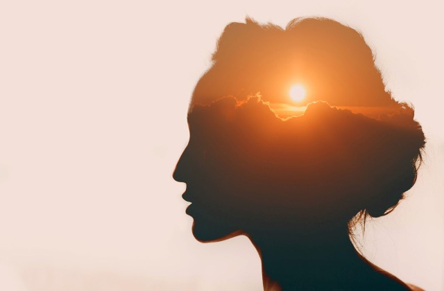 Mental Health Awareness Month - sunset within a person's silhouette 
