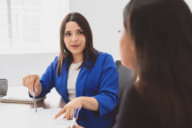 Woman discussing business with coworker