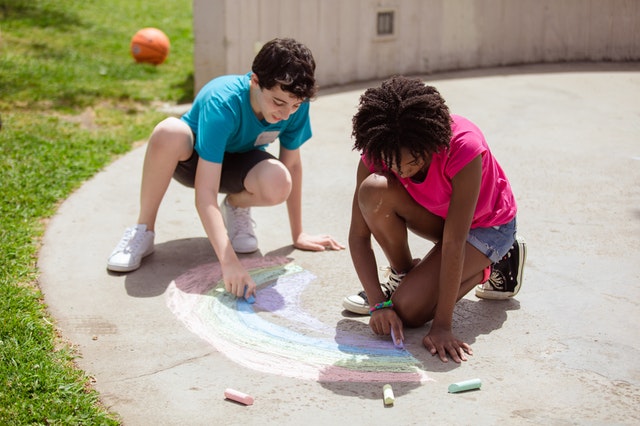 Boy and Girl drawing with chalk, summer camp insurance Cedar Park Texas