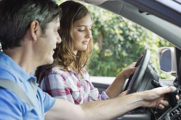 Dad teaching daughter to drive - auto insurance Texas