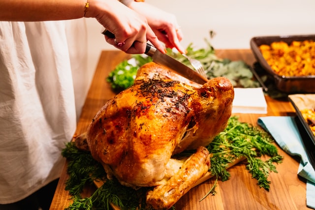 Person preparing turkey dinner.
