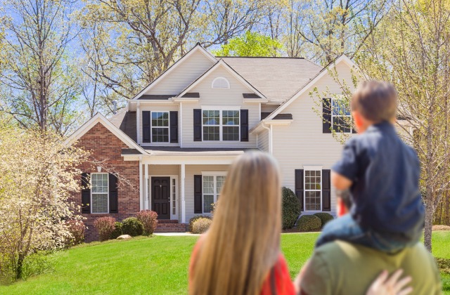 Family standing outside family - Avoid underinsuring your home