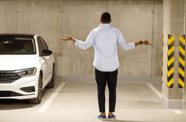 Man standing in front of empty parking spot, car stolen