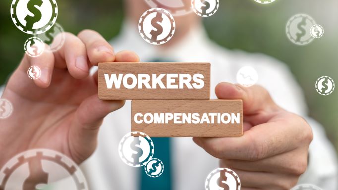 Hands holding blocks with words "workers compensation" on them