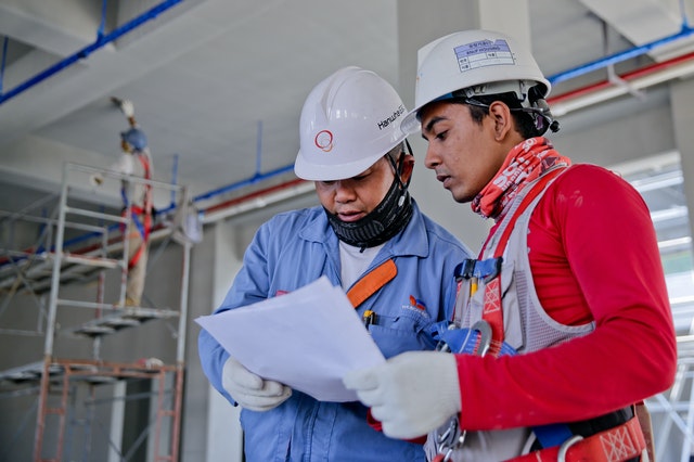 Two construction workers looking at plans